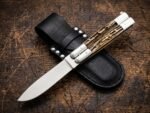 Musang Asian Palm Civet balisong butterfly knife shown with its leather sheath, second view
