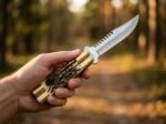 Banded Sugar Ant balisong butterfly knife held in hand