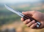 Aurochs balisong butterfly knife held in hand