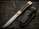 Deer balisong butterfly knife shown with its leather sheath