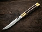 Glow Worm balisong butterfly knife open with the blade showing