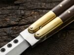 Close up of the Glow Worm balisong butterfly knife bolster and pivot