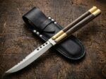 Glow Worm balisong butterfly knife shown with its leather sheath