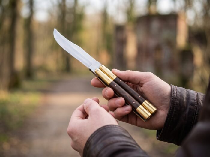 Barn Owl balisong butterfly knife held in hand