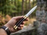 Human balisong butterfly knife held in hand, second view