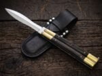 Ladybug balisong butterfly knife shown with its leather sheath