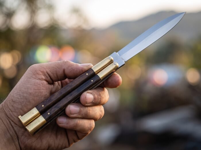 Masked Palm balisong butterfly knife held in hand