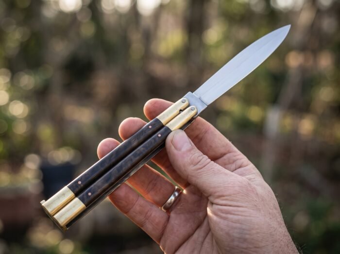 Millipede balisong butterfly knife held in hand