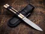 Pangolin balisong butterfly knife shown with its leather sheath