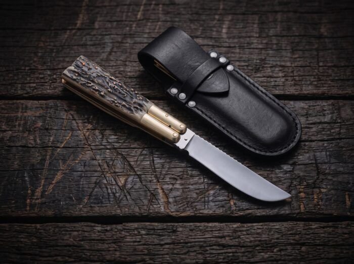 Balete balisong butterfly knife shown with its leather sheath