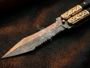 BF-145 Damascus balisong butterfly knife, layered Damascus blade, black horn handle with engraved brass bolsters (view 1)