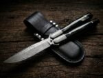 Hatinggabi balisong butterfly knife shown with its leather sheath, third view