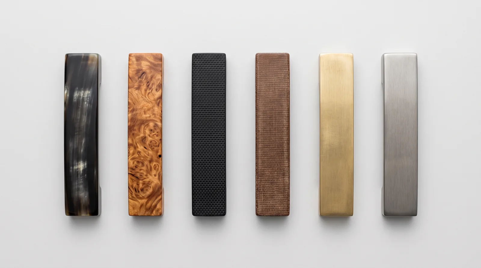 Six balisong handle material samples: buffalo horn, hardwood, G10, canvas micarta, brass and titanium