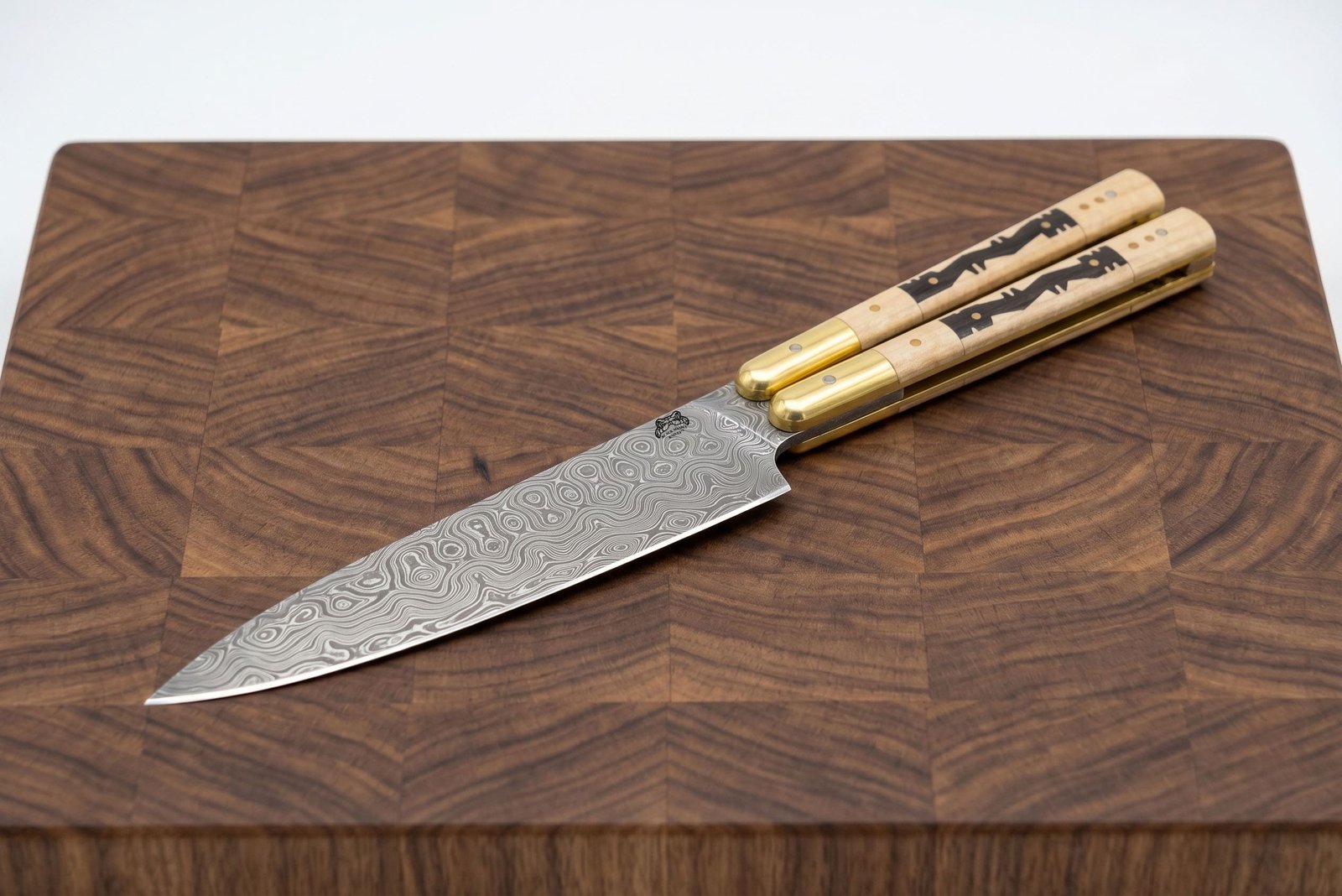 Handmade Damascus balisong chef knife with buffalo bone handle and brass bolsters Handmade Damascus balisong chef knife with buffalo bone handle and brass bolsters