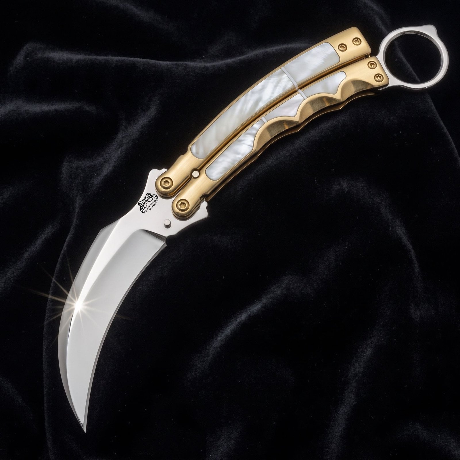 Handmade karambit balisong butterfly knife with mirror polished blade and mother of pearl handle in a brass frame Handmade karambit balisong butterfly knife with mirror polished blade and mother of pearl handle in a brass frame