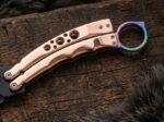 Close up of the Liyab karambit balisong knife handle