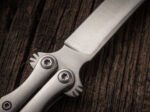 Close up of the Saluhan balisong steak knife and fork set bolster and pivot