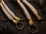 Buffalo bone handle scales and brass finger rings of the karambit balisong BF-182