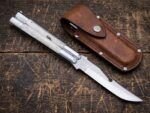 Moth balisong butterfly knife closed beside its brown leather sheath
