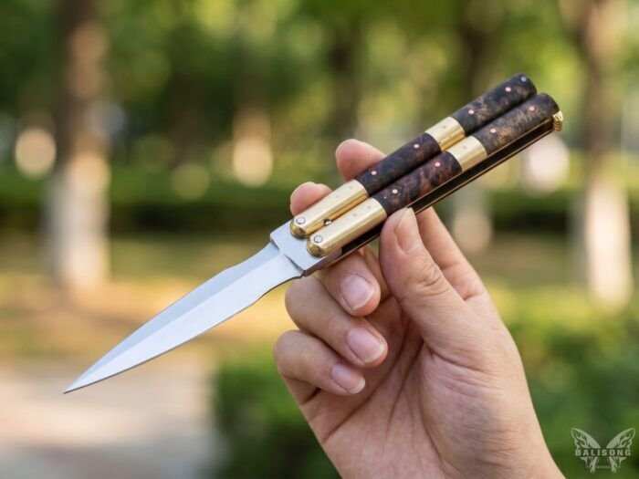 Tulis Pandayan dagger balisong butterfly knife held open in hand outdoors